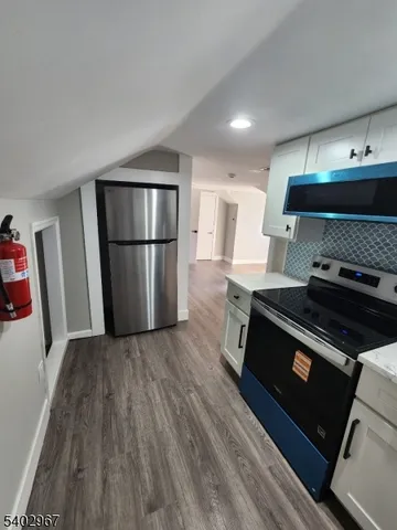 a kitchen with a stove and a refrigerator