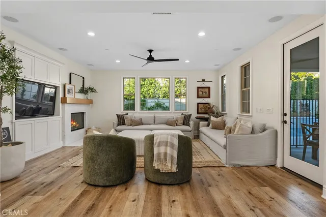 a living room with fireplace furniture and a flat screen tv