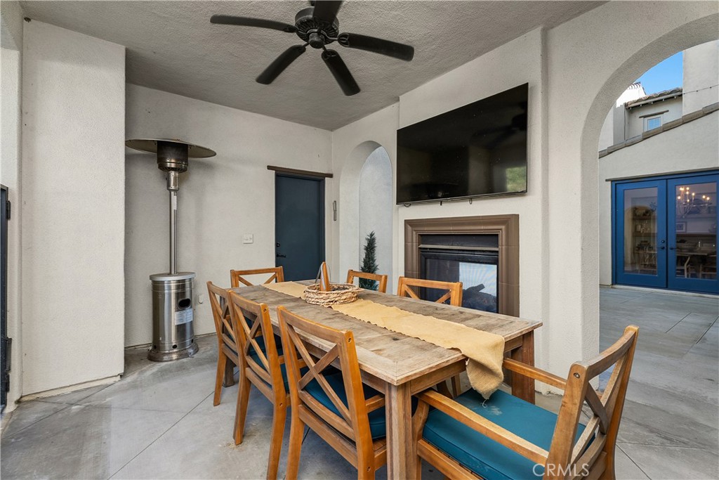 32 Michael Ladera Ranch, CA 92694 - Photo 19 of 44 a dining room with furniture a flat screen tv and a fireplace