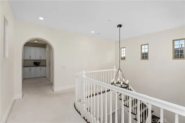 a spacious bedroom with a bed and a cabinets