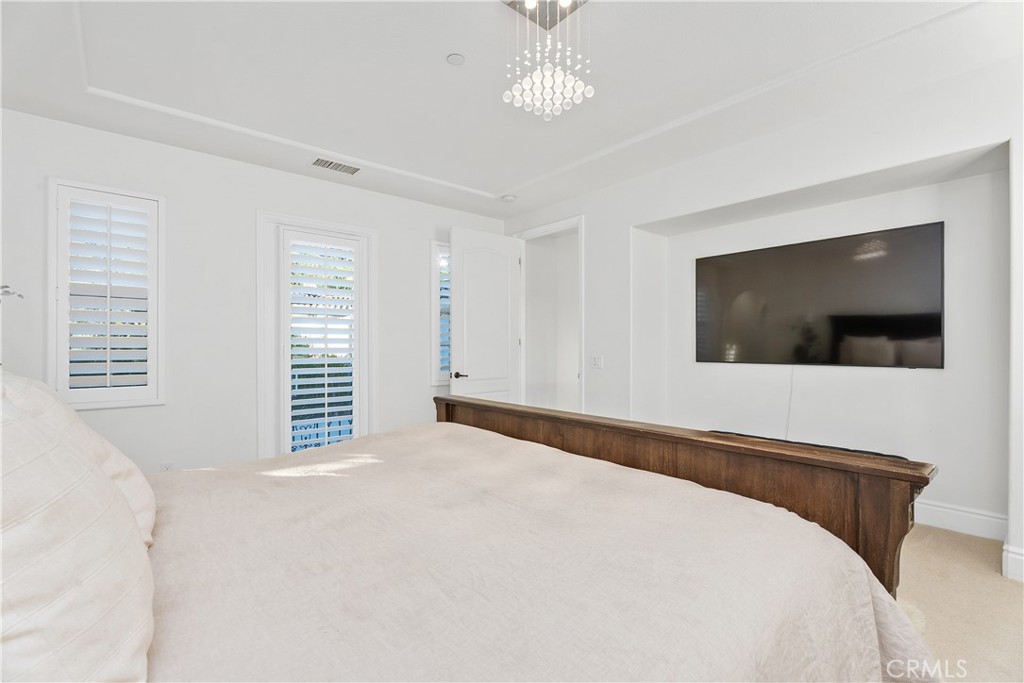 32 Michael Ladera Ranch, CA 92694 - Photo 27 of 44 a bedroom with a large bed and a flat screen tv