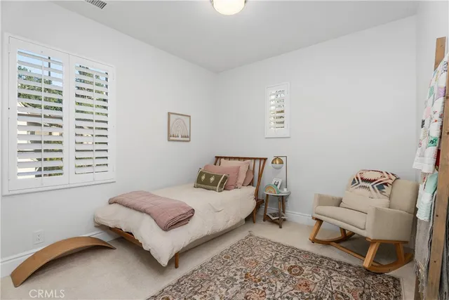 a bedroom with bed and a window