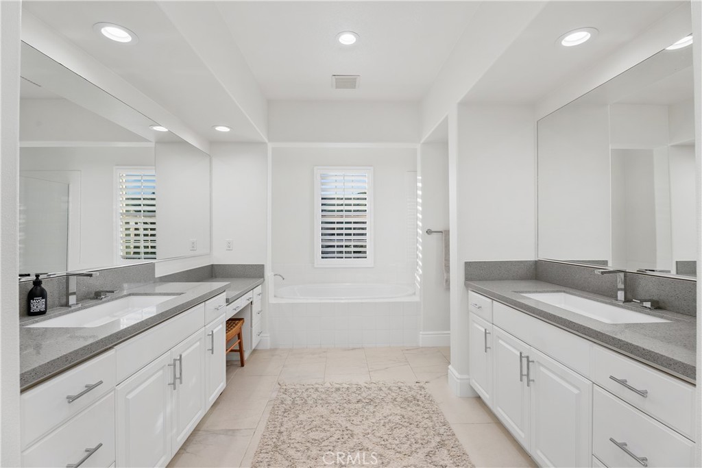 32 Michael Ladera Ranch, CA 92694 - Photo 33 of 44 a spacious bathroom with a granite countertop double vanity sink a mirror and a bathtub