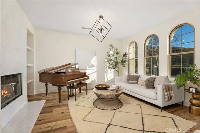 a living room with furniture a dining table and a fireplace