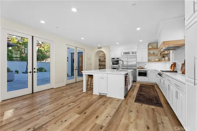 a kitchen with a sink and wooden floor