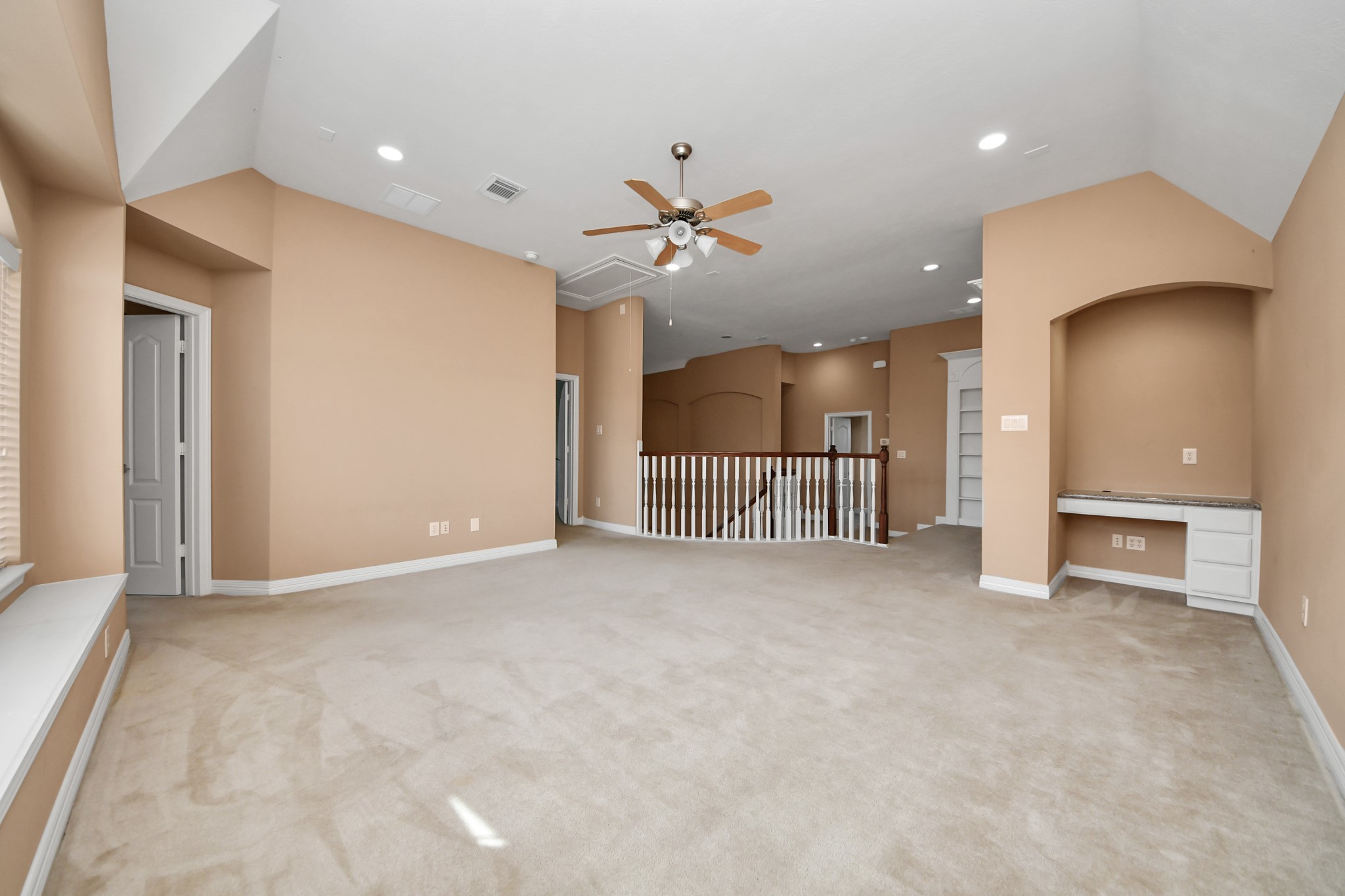 17618 Raven Canyon Lane Houston, TX 77095 - Photo 27 of 45 Spacious game room area featuring vaulted ceilings and ample natural light from the large windows.