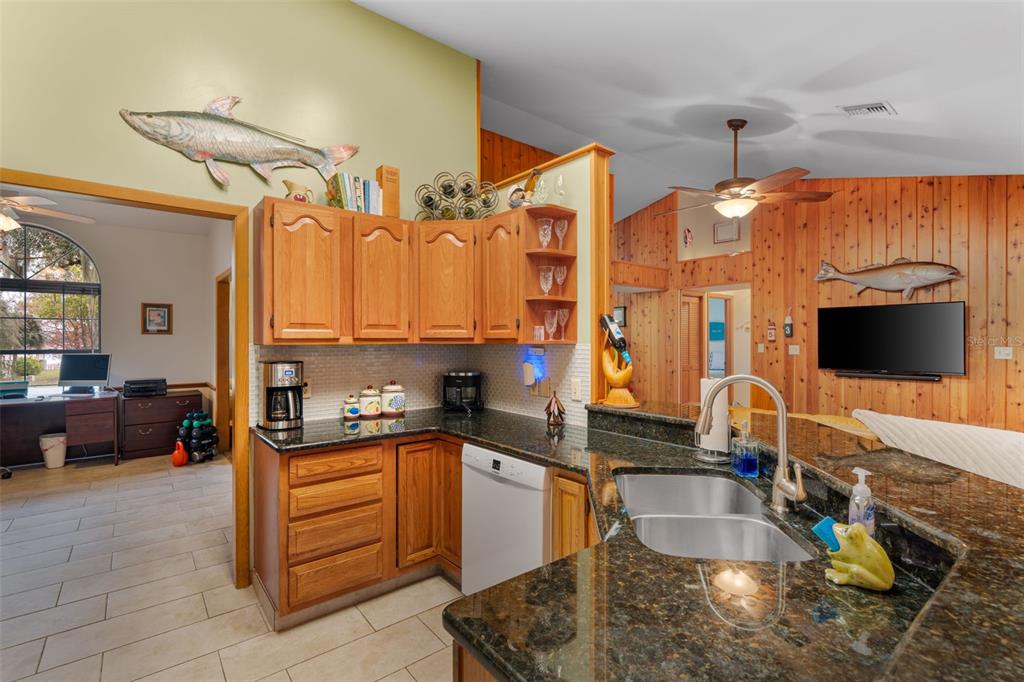 14334 Raintree Boulevard Grand Island, FL 32735 - Photo 13 of 40 a kitchen with granite countertop a sink and a stove top oven