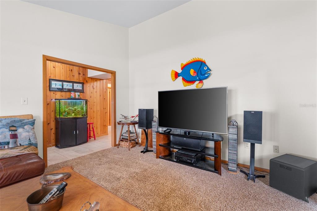 14334 Raintree Boulevard Grand Island, FL 32735 - Photo 20 of 40 a living room with furniture and a flat screen tv