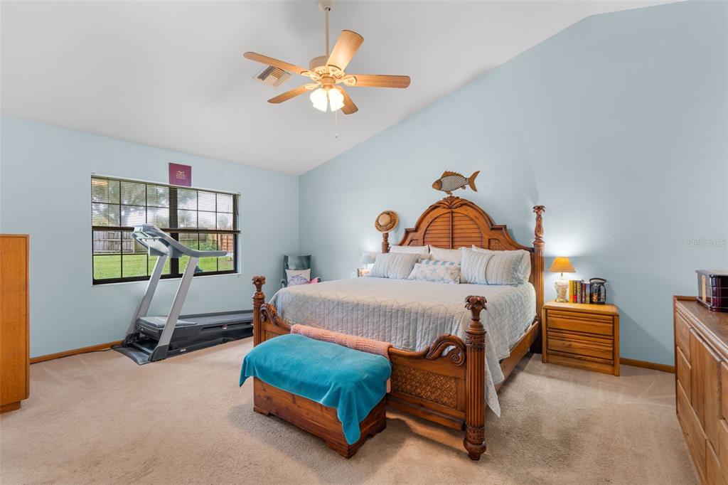 14334 Raintree Boulevard Grand Island, FL 32735 - Photo 21 of 40 a bedroom with a bed and a window