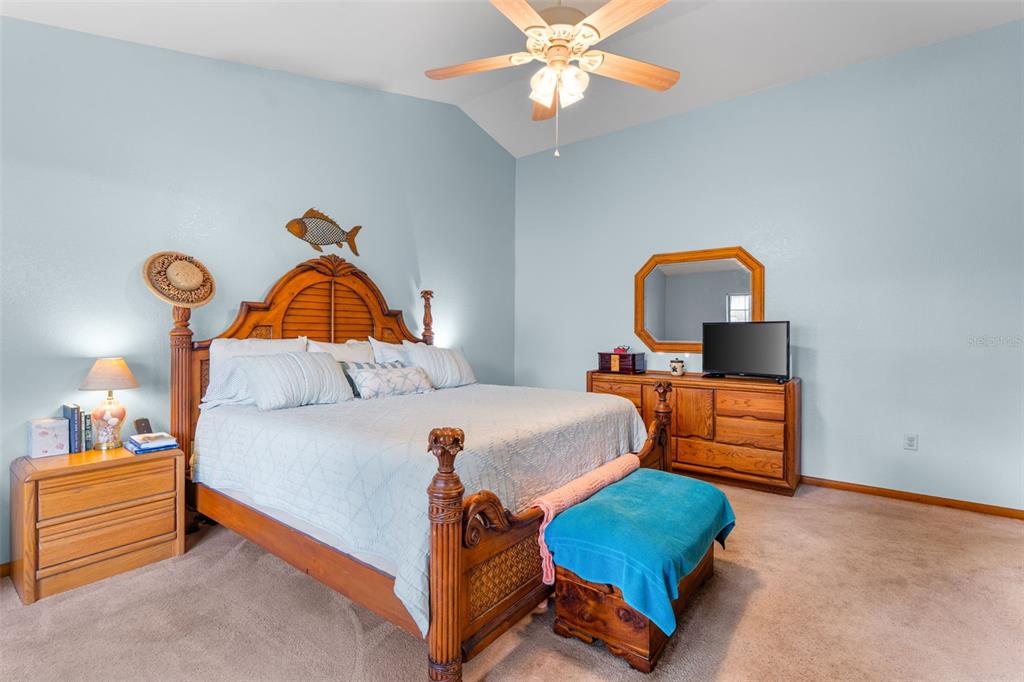 14334 Raintree Boulevard Grand Island, FL 32735 - Photo 22 of 40 a bedroom with a bed and dresser