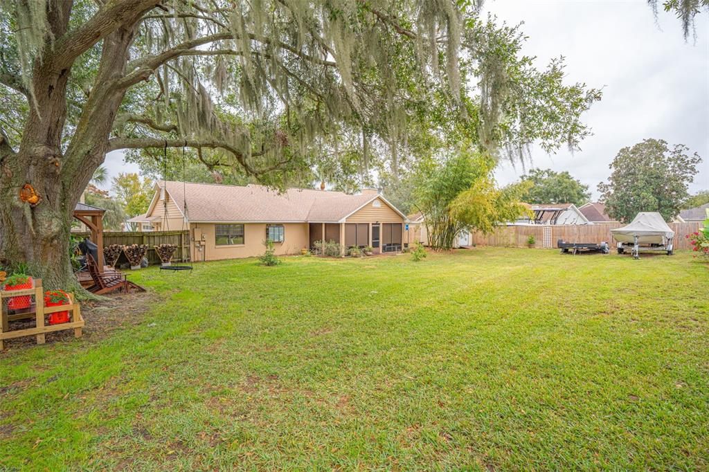 14334 Raintree Boulevard Grand Island, FL 32735 - Photo 35 of 40 a view of a house with backyard and sitting area