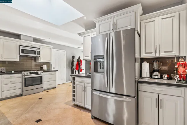 a kitchen with stainless steel appliances a refrigerator stove and sink