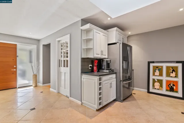 a kitchen with stainless steel appliances a refrigerator and a stove top oven