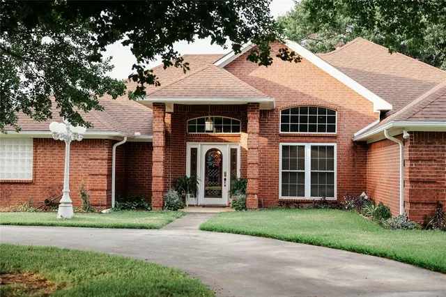 a front view of a house with a garden and plants