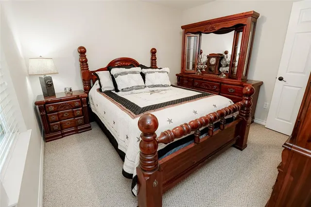 a bed sitting in a bedroom next to a mirror