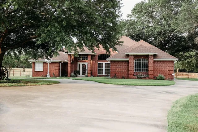 a view of a house with a yard and sitting area