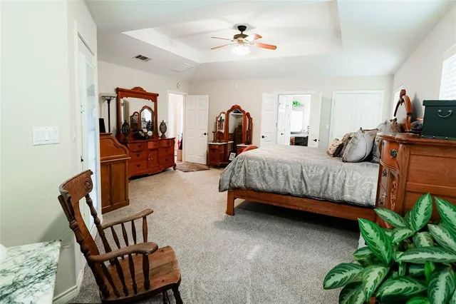 a bedroom with furniture and a flat screen tv