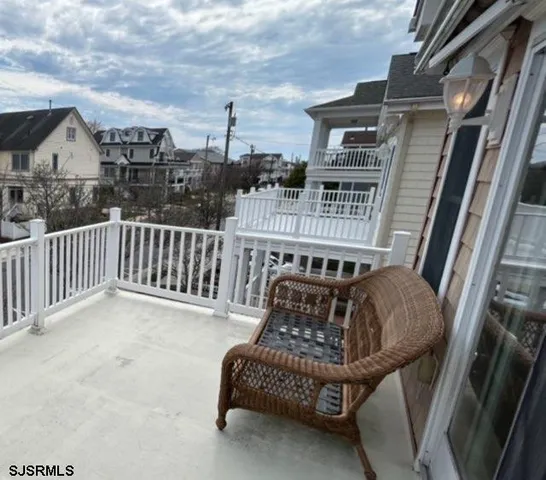 a view of a chair and tables in the balcony