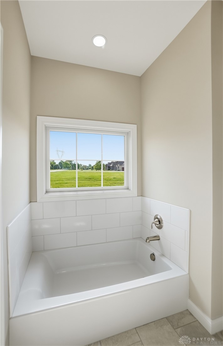 4600 Beal Road Franklin, OH 45005 - Photo 20 of 42 This serene bathroom offers a bright tub, perfect for relaxation with a peaceful outdoor view.