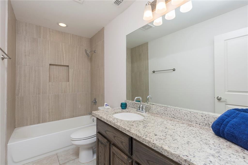 14337 Chalk Rdg Drive McAllen, TX 78504 - Photo 12 of 21 Clean and modern bathroom with granite vanity, tiled shower/tub combo and stylish finishes
