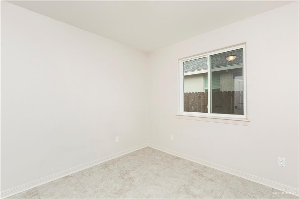 14337 Chalk Rdg Drive McAllen, TX 78504 - Photo 13 of 21 Cozy secondary bedroom with natural light and a clean, versatile layout ready for your personal touch