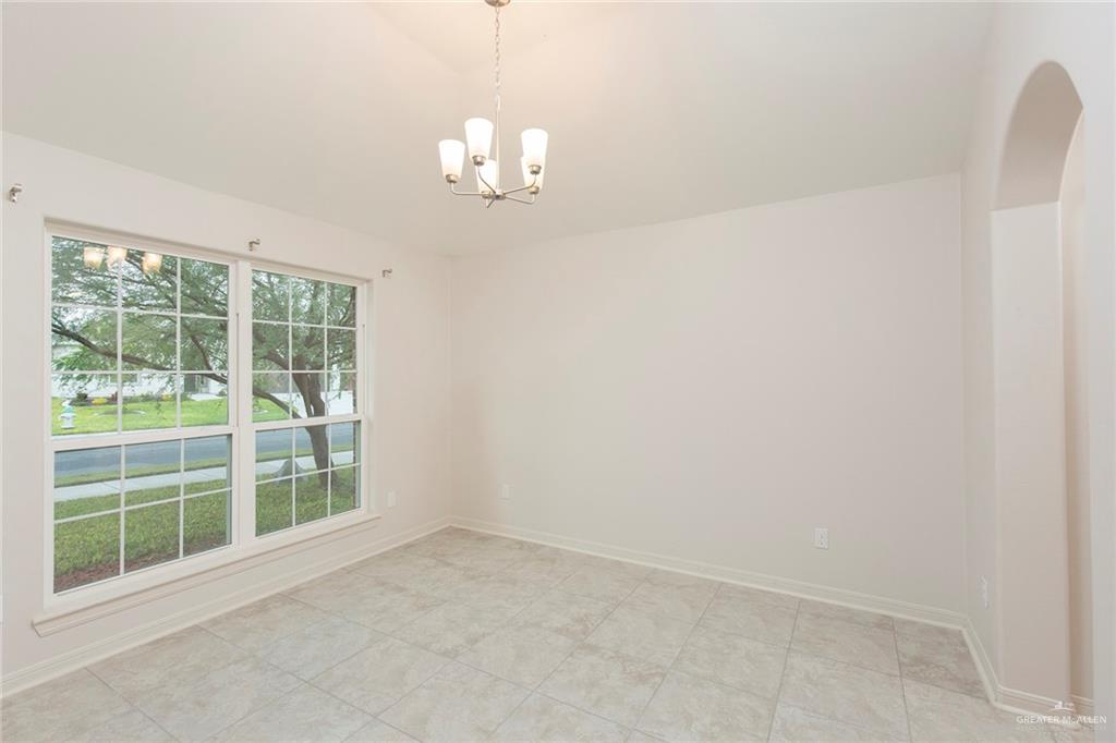 14337 Chalk Rdg Drive McAllen, TX 78504 - Photo 4 of 21 Charming dining area with vaulted ceilings, elegant lighting and large windows filling the space with natural light