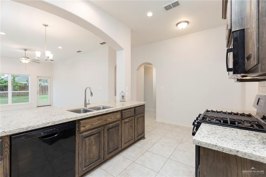 14337 Chalk Rdg Drive McAllen, TX 78504 - Photo 6 of 21 Open-concept kitchen with a large island, granite countertops and seamless flow into the living space—perfect for entertaining