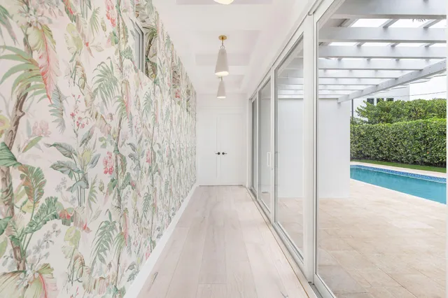 a view of a hallway with wooden floor and a window