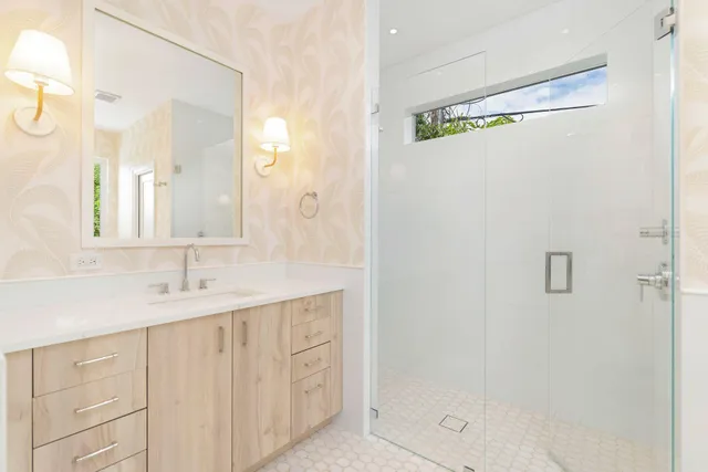 a bathroom with a shower sink and mirror
