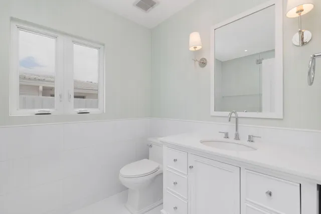 a bathroom with a sink vanity and a mirror