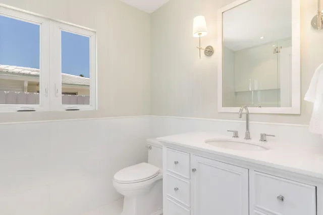 an empty room with a window and wooden floor