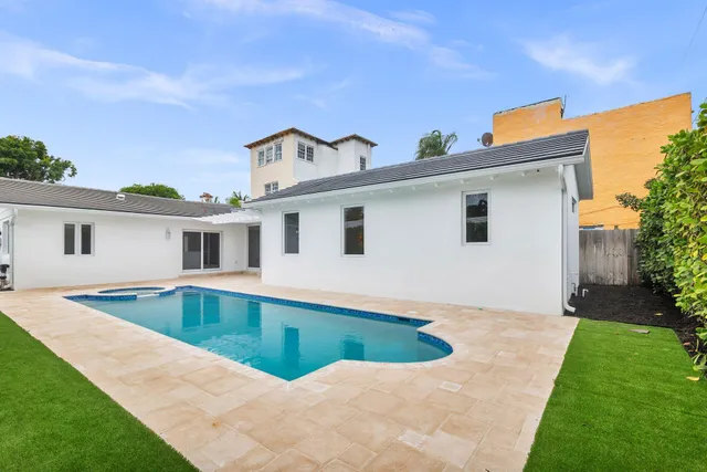 an aerial view of a house with a swimming pool