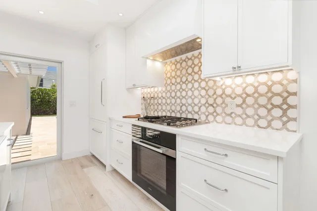 a kitchen with a stove and a white cabinet