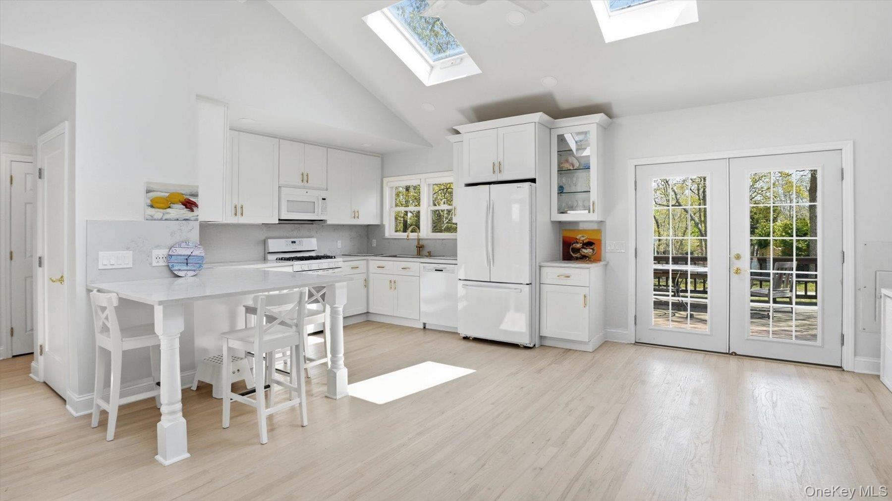 32 Red Creek Road Hampton Bays, NY 11946 - Photo 8 of 18 a kitchen with stainless steel appliances a refrigerator and a stove top oven