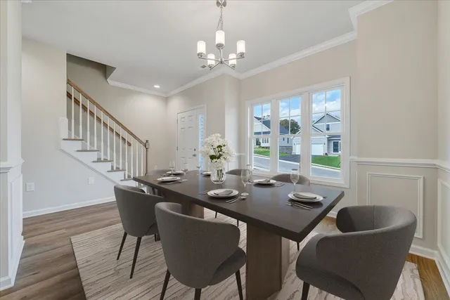 a view of a dining room with furniture wooden floor and chandelier