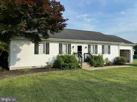 a front view of house with yard and green space
