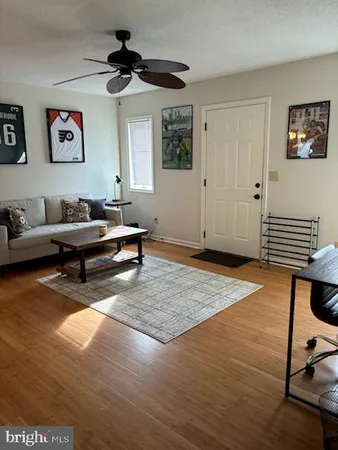 a living room with furniture and wooden floor