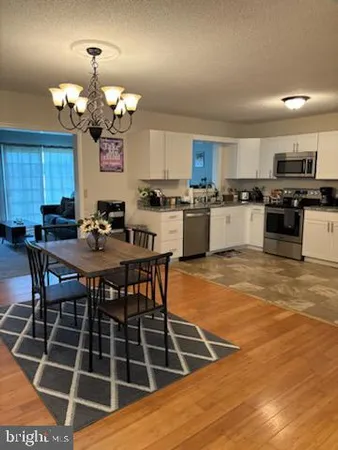 a kitchen with a dining table and chairs