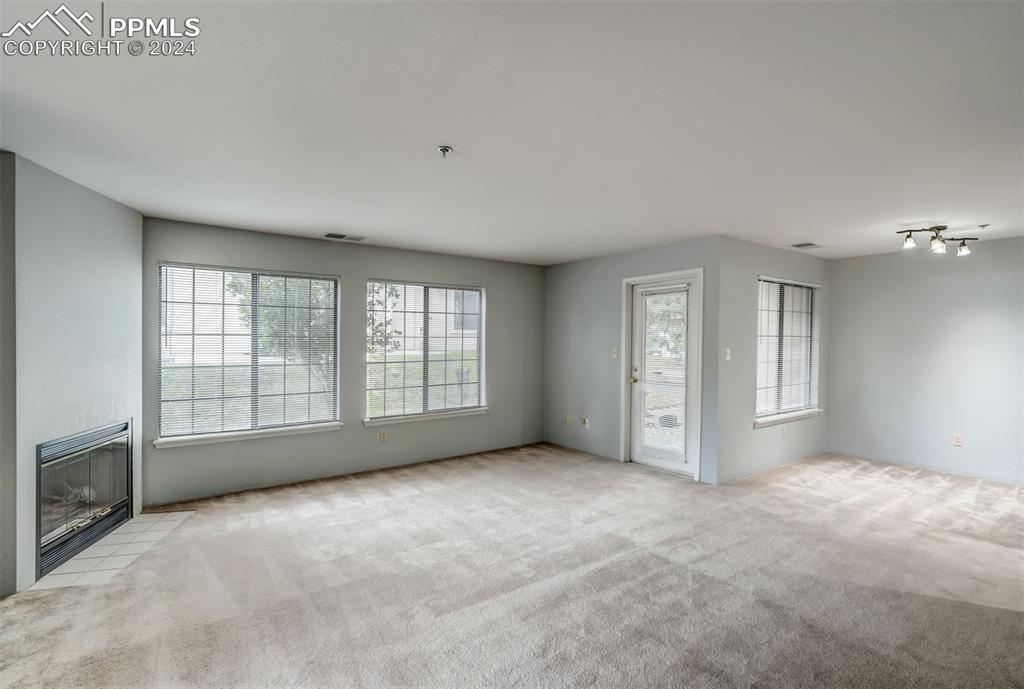 2195 Alicia Point, Unit 102 Colorado Springs, CO 80919 - Photo 11 of 36 a view of an empty room with a window