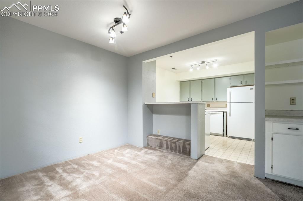 2195 Alicia Point, Unit 102 Colorado Springs, CO 80919 - Photo 12 of 36 a view of a kitchen with refrigerator and a sink