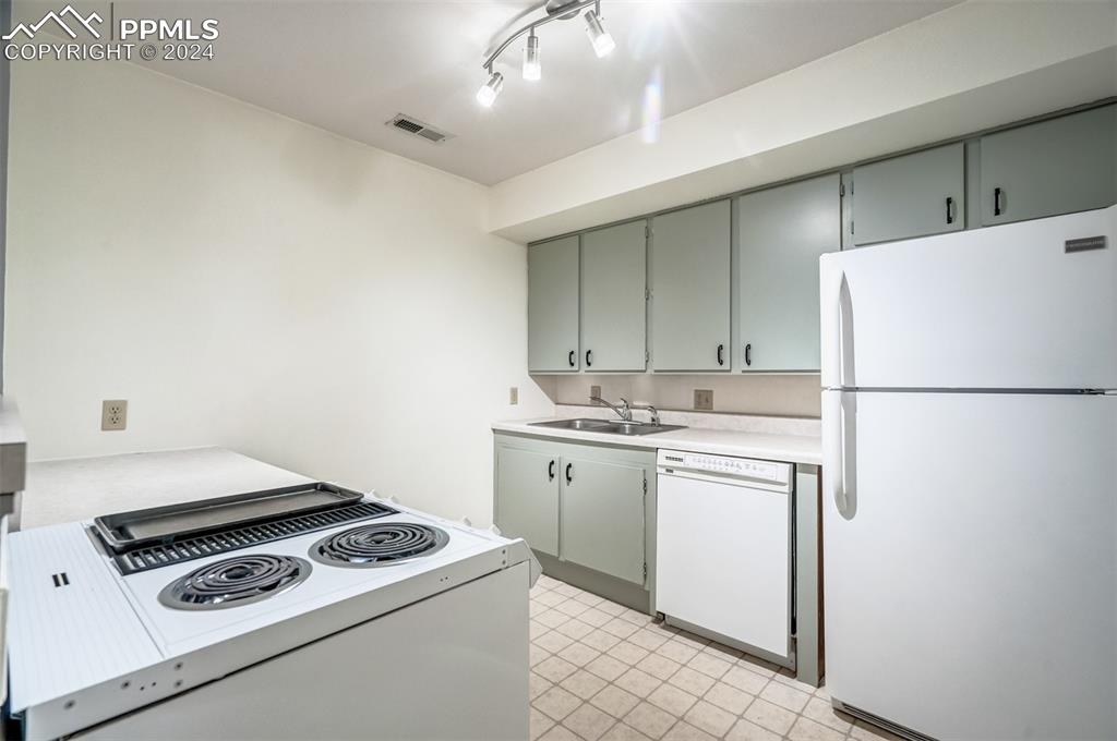 2195 Alicia Point, Unit 102 Colorado Springs, CO 80919 - Photo 13 of 36 a kitchen with a stove and a refrigerator