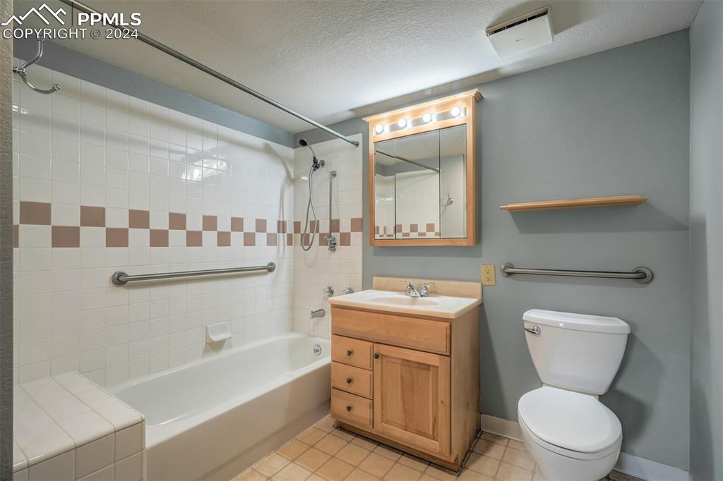 2195 Alicia Point, Unit 102 Colorado Springs, CO 80919 - Photo 23 of 36 a bathroom with a toilet sink and mirror