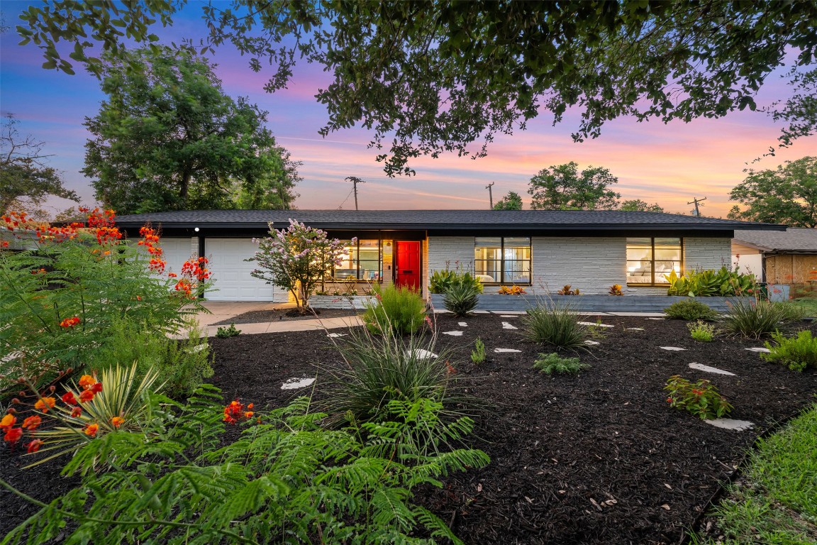 a view of a house with a flower garden