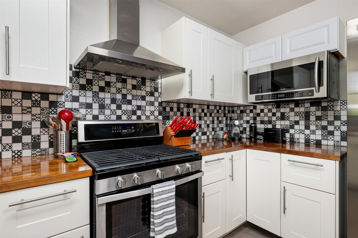 1806 Rogge Lane Austin, TX 78723 - Photo 12 of 40 a kitchen with stainless steel appliances a stove and a microwave