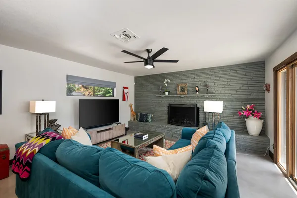 a bedroom with a bed a couch and a large window