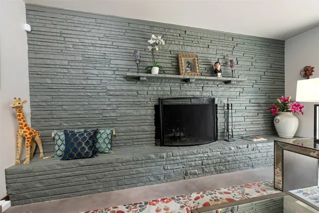 a bedroom with a bed a couch and a large window