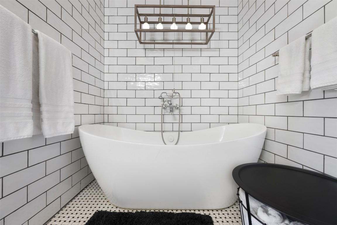 1806 Rogge Lane Austin, TX 78723 - Photo 20 of 40 a white bath tub sitting in a bathroom