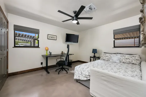 a bedroom with a bed and a chandelier