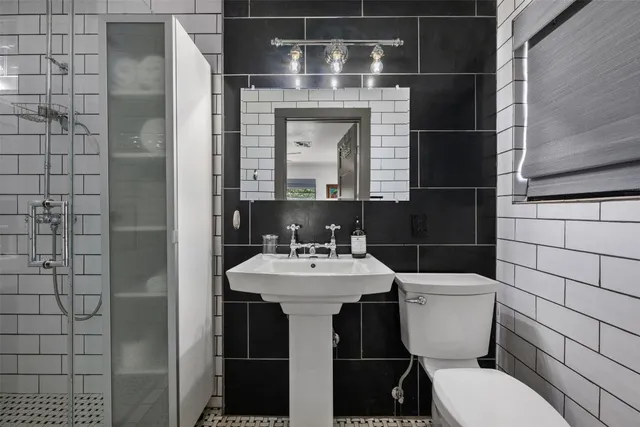 a bathroom with a sink a mirror and shower