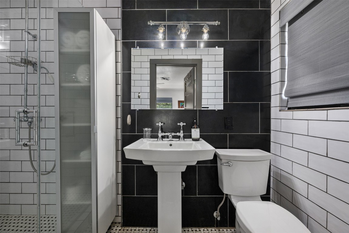 1806 Rogge Lane Austin, TX 78723 - Photo 25 of 40 a bathroom with a sink toilet and shower